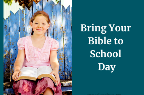 Young, smiling girl holding Bible. Text: Bring Your Bible To School Day