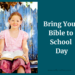 Young, smiling girl holding Bible. Text: Bring Your Bible To School Day