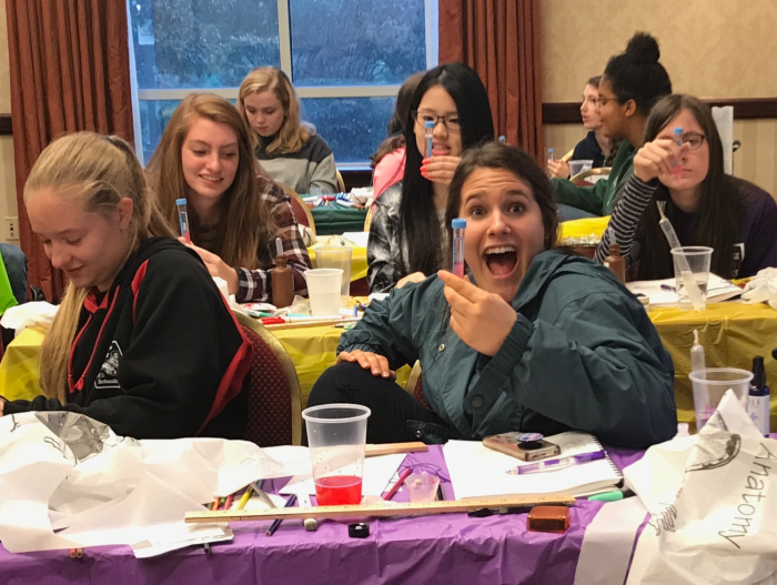 Homeschool Science Curriculum for Non-Science Students. Shows smiling students holding vials. (Photo courtesy of College Prep Science).