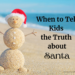 Snowman built out of sand with Santa cap. Title: When to Tell Kids the Truth about Santa