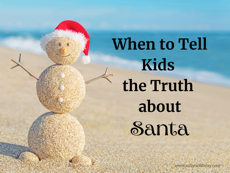 Snowman built out of sand with Santa cap. Title: When to Tell Kids the Truth about Santa